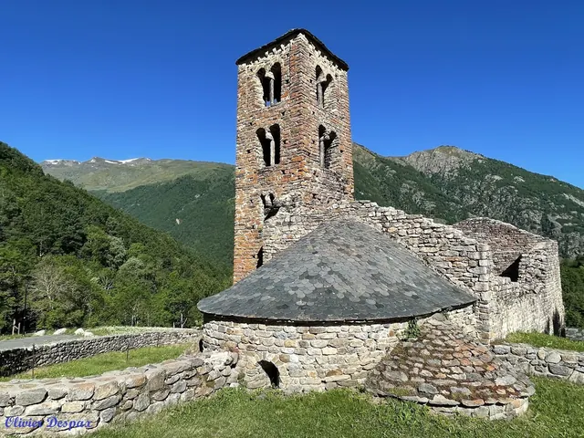 Ancient stone tower and ruins with a slate roof located in the green mountainous area near Merens-les-Vals in France.