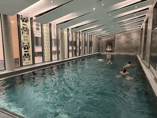 swimming pool inside spa building with a few people enjoying the water at imperial spa house near teplice in czechia.