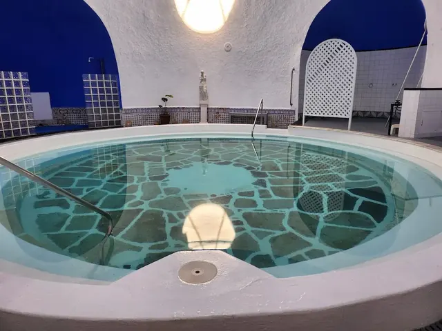 Indoor hot spring tub with tiled floor at balneario de alange in spain