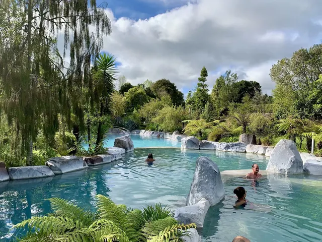 Large natural outdoor hot spring pool at Wairakei Terraces surrounded by lush greenery near Taupō new-zealand.