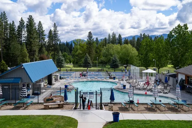 Outdoor hot spring pool and sports courts with forest valley views at terrace lakes hot springs idaho