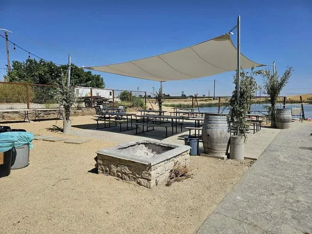 Shaded patio with hot spring pool in the background at franklin hot springs california
