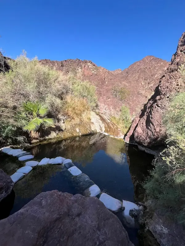 natural hot spring pools overlooking a desert gorge at lone palm hot springs in arizona