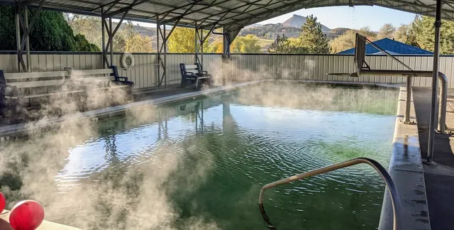 steaming hot spring pool with mountain valley views at roystone hot springs idaho