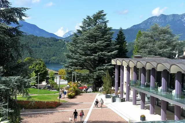 Front view of terme di levico with lake and mountans in the backdrop in italy