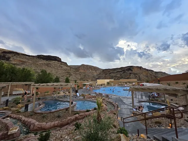Several outdoor soaking pools and a large hot spring pool at Zion Canyon Hot Springs with surrounding rocky hills near La Verkin Utah.