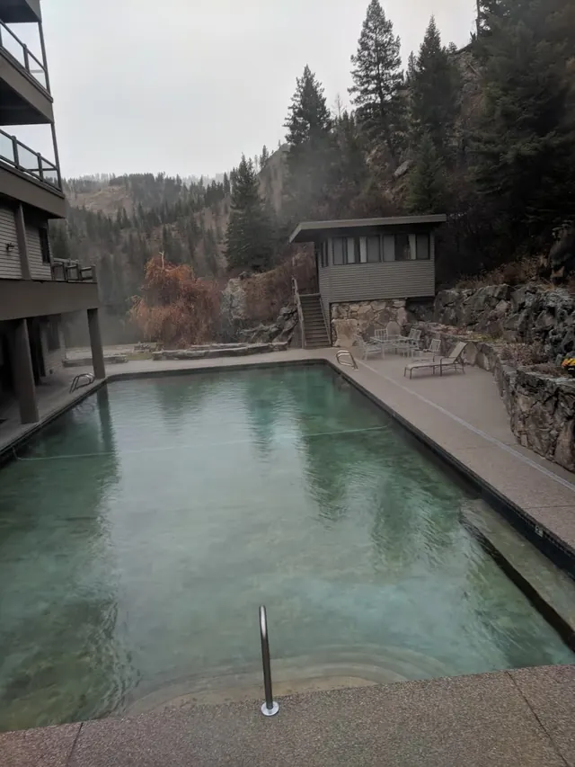 Outdoor rectangular hot spring pool with clear water and light steam at Sleeping Child Hot Springs near Hamilton montana.