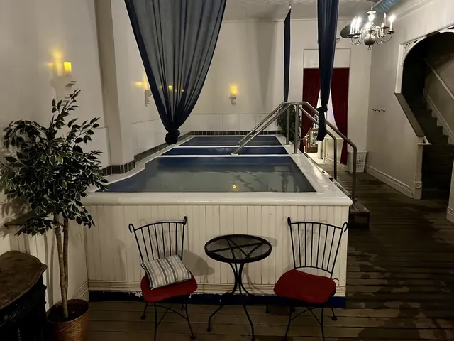 Three indoor hot spring pools with handrails and cozy seating area inside Overlook Hot Springs Spa in Pagosa Springs, Colorado.