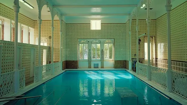 Indoor hot spring pool with natural lighting at termas de caldelas in portugal