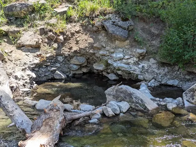 Natural hot spring pools along a creek at frenchmans bend hot springs in idaho