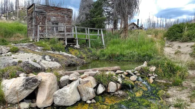 a shed alongside Natural hot spring stream and pool at dash creek hot springs idaho