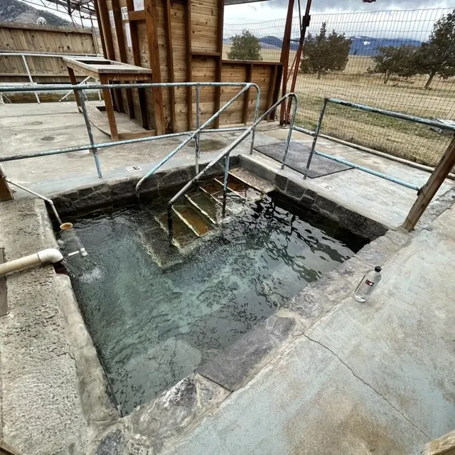 concrete hot spring tub with clear water at camp aqua hot springs