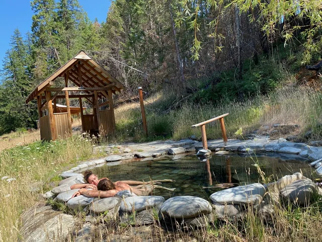 Outdoor soaking pools beneath a wooden shelter — Breitenbush Hot Springs