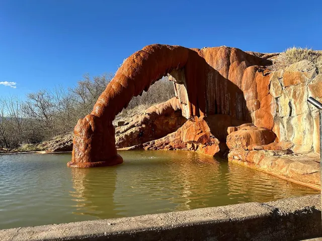 Concrete lined hot spring pools with natural rock formations at mystic hot springs utah