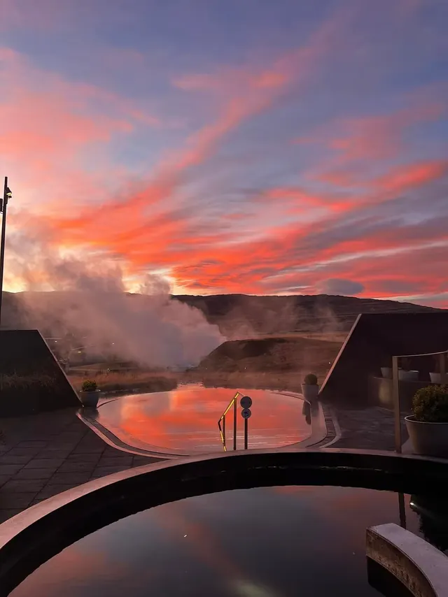 Steaming geothermal pool at sunset in Krauma Geothermal Baths, Iceland