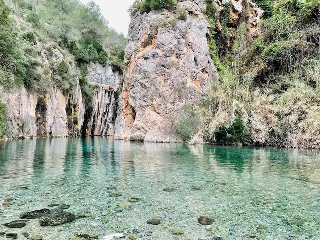 Clear waters of a hot spring pool surrounded by a gorge at fuente de los banos in spain