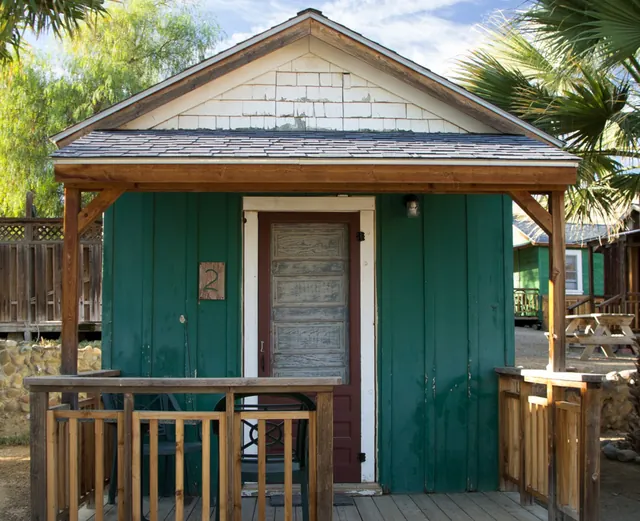 Cabin exterior; accommodation is separate from pool admission — Mercey Hot Springs