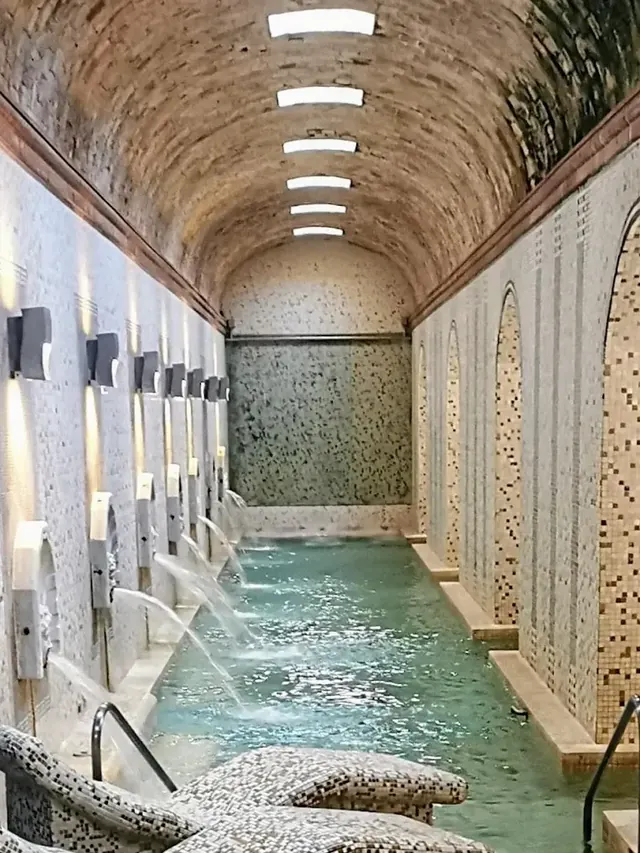 Indoor hot spring pool with massage streams at balneario termas pallares in spain