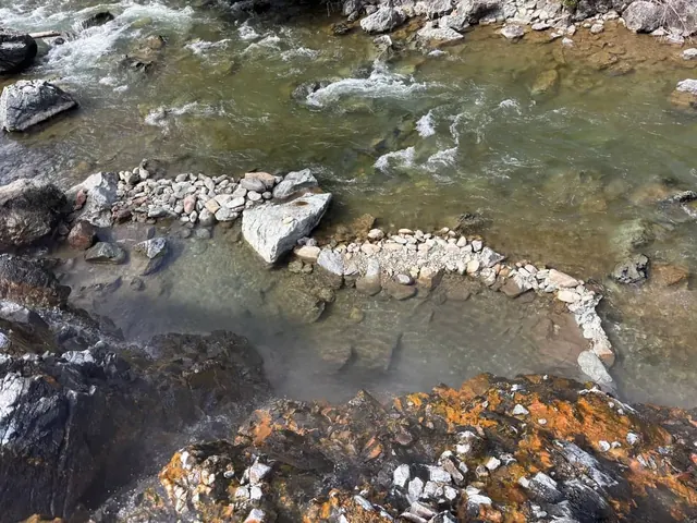Natural rock lined hot spring pool along the river at lower loon creek hot spring idaho