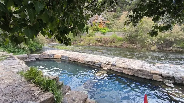 Outdoor concrete hot spring pools next to a river at pozas de arnedillo in spain