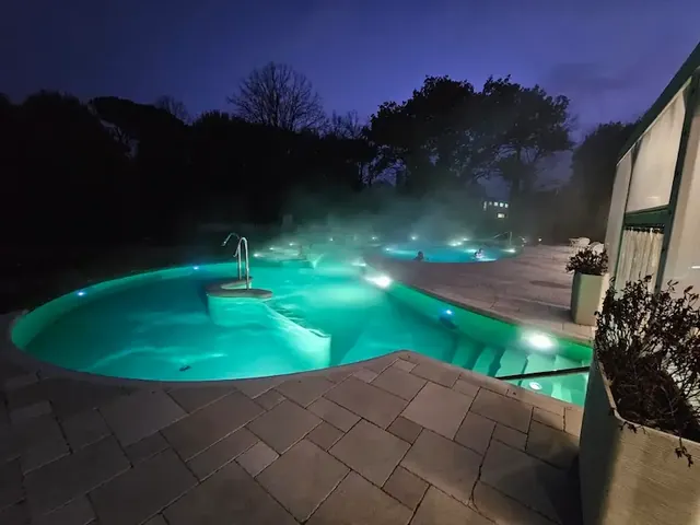 Outdoor steaming thermal pools in the evening at terme di castrocaro in italy